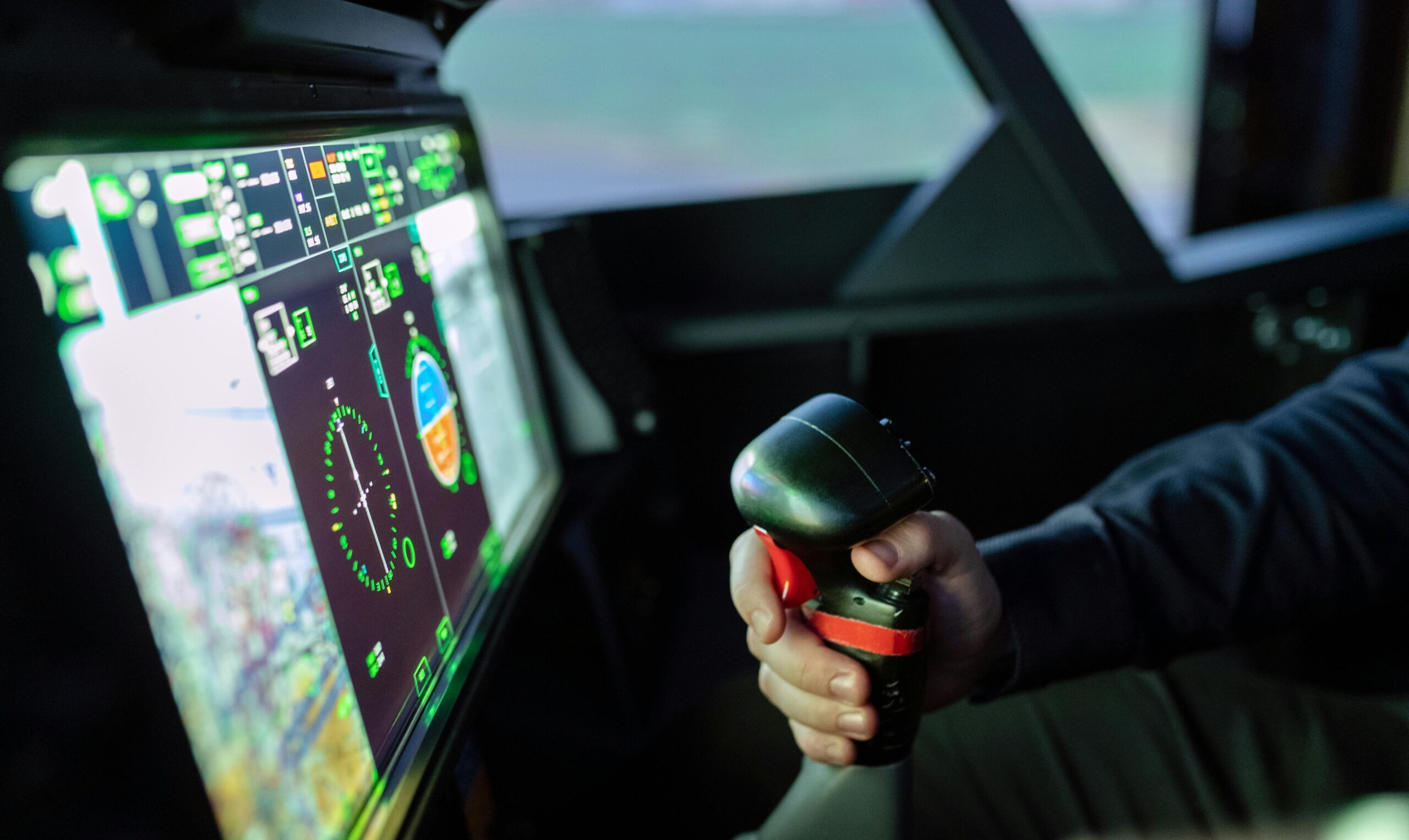 Close-up of a simulated aircraft cockpit with control joystick and digital display.